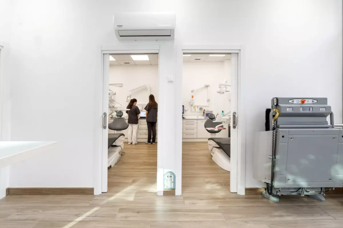 Vista de dos puertas, en cada una una sala con sillones de dentista